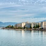 Charming waterfront cityscape of Chalkida, Greece, featuring picturesque buildings by the tranquil sea.