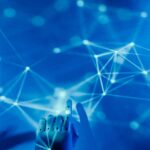 Futuristic robotic hand touching a digital network on a blue background.