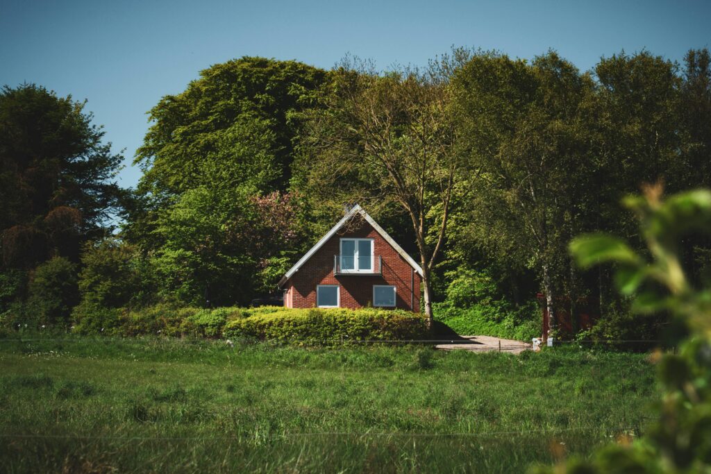 Scenic view of a quaint brick house surrounded by trees in Denmark, perfect for a peaceful getaway.