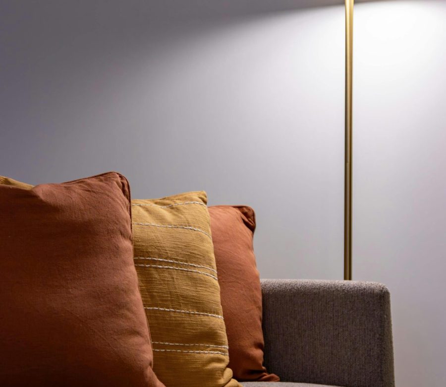 Elegant living room scene featuring a modern lamp and a comfortable sofa with cushions in Portugal.