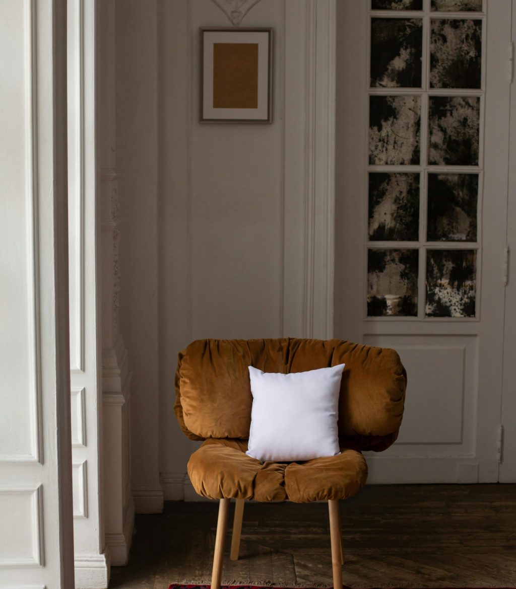 Elegant velvet chair with a white pillow in a vintage styled room, perfect for comfort and decor.