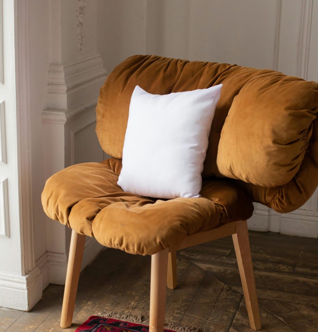 Warm velvet chair with white pillow in classic interior setting, perfect for comfort and style.